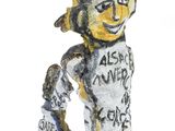 statue of a man with a hat and glasses holding a skateboard