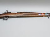 an old rifle with a wooden barrel and a wooden handle