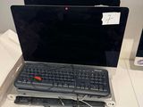 a laptop computer sitting on a desk with a keyboard