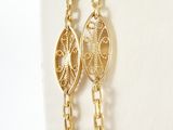 pair of gold plated earrings with a chain link and a coin