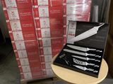 a box of knives on a table next to a stack of boxes
