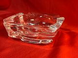 cendrier en verre posé sur un tissu rouge, sur fond rouge