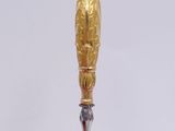 an image of a silver and gold bottle with a gold handle