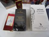 many different perfumes on a table with a white table cloth