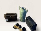 three binoculars, a vase, and a box on a white surface