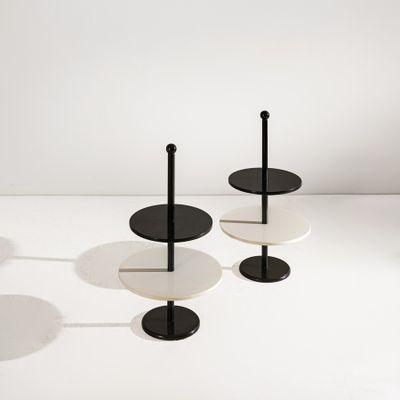 trois tables noires et blanches posées sur une surface blanche, sur fond blanc