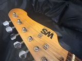 an electric guitar with a wooden neck and a black case