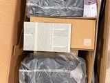 a cardboard box with two bags of items inside of it