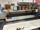 an image of a counter with a lot of pizzas on it
