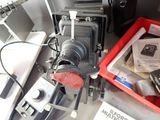 a camera sitting on top of a table next to a red bin
