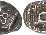 a close up of a coin with a skull on it