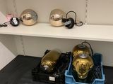 a shelf that has a bunch of gold helmets on it