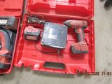 a red tool box with tools in it on the floor