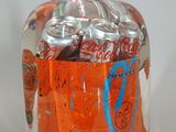 a can of soda and a can of soda in a bag