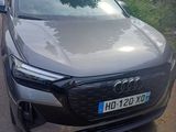 audi ' s new electric suv is parked on the side of the road