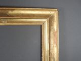 an old picture frame on a wall with a black wall in the background