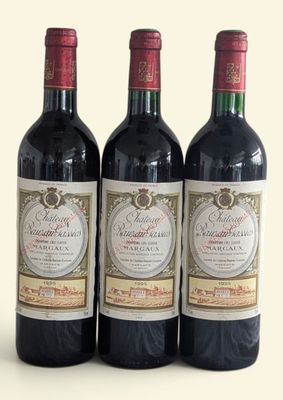 three bottles of red wine sitting next to each other on a white surface