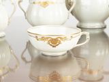 five cups and a saucer sitting on a table