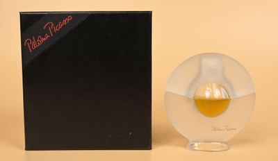 a close up of a bottle of perfume next to a box