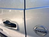 a close up of a car door handle with a nissan logo on it