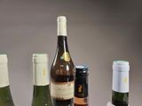 several bottles of wine are lined up on a table