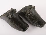 pair of old wooden shoes on a white surface