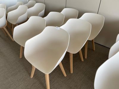 many white chairs lined up in a row on the floor