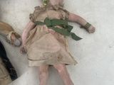 two dolls laying next to each other on the snow