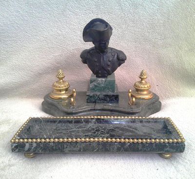 a statue of a man with a hat on top of a table