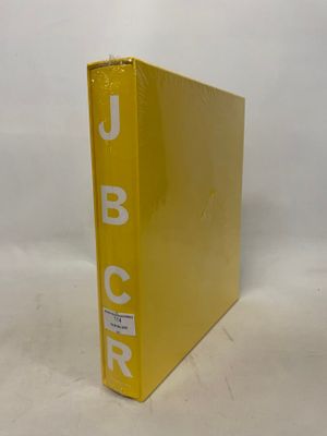 yellow binder with white letters on it sitting on a white surface