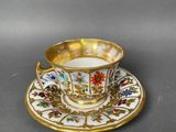 a close up of a cup and saucer on a table