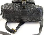 a black purse with a snake skin pattern on it