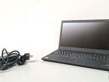 a laptop that is sitting on a table with a charger