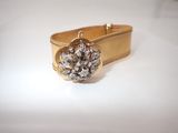 an image of a gold ring with a flower on it