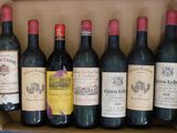 several bottles of wine are in a cardboard box on a table