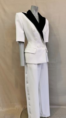 a mannequin wearing a white suit with black trimmings