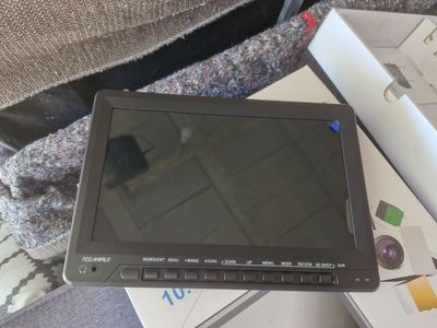 a tablet computer sitting on top of a pile of books