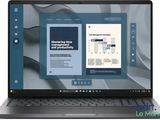 the laptop is open on a white background with a book on the screen