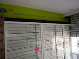 a large display case in a store with a green sign above it