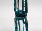 a blue glass vase that is sitting on a white surface