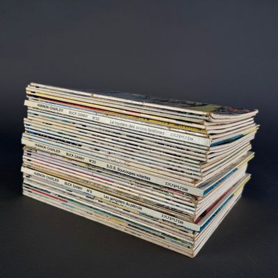 a stack of magazines sitting on a table with a black background