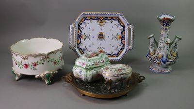 three different pieces of porcelain on display on a table