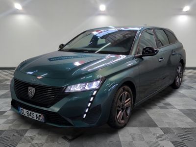 a picture of a green car in a showroom