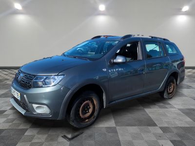 the grey car is parked on a checkered floor in a room