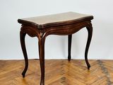 an image of a wooden table with a marble top on a parquet floor