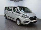 the silver van is parked in the large room of the building