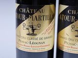 two bottles of wine sitting next to each other on a table