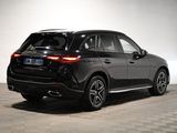 the rear end of a black mercedes suv parked in a garage