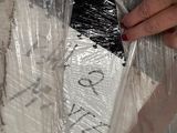 a person that is putting something in a plastic bag