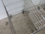 a metal cage that is sitting on the floor